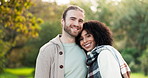 Face, smile and interracial couple in nature, bonding and having fun together. Portrait, love and happy man and African woman with care, date and enjoy quality time outdoor on vacation for romance.