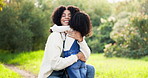 Mother, love and hug in nature for embrace, bonding and affection outdoor. African mom, happy and care, cuddle with mama and smile, having fun and enjoying quality time together on family vacation.