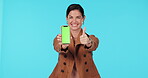 Green screen phone, thumbs up or happy woman point at mockup travel app, brand satisfaction feedback or media space. Approval portrait, cellphone logo or studio person voting on ad on blue background