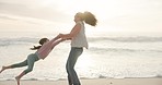 Happy, swinging and a mother with a child at the beach for bonding, playing and summer together. Smile, holding hands and mom being playful with a little girl for fun at the sea during a holiday