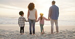 Family, holding hands and children on beach at sunset together on holiday or vacation for bonding fun. Man, woman and girl kids from behind for quality time, travel adventure and wellness at ocean