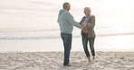 Senior couple, dancing and beach at sunset while happy together on vacation or date with energy. Mature man and woman embrace at the ocean with love, care and romance on a retirement holiday