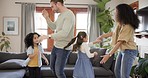 Happy family, dance and fun with kids and parents in a living room happy, excited and music in their home. Love, bonding and children with mother and father in a lounge dancing to radio or podcast