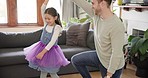 Family, happy father and girl dance in living room for bonding, quality time and dancing at home. Happiness, playful and dad spin daughter for having fun, learning and teaching move for loving bond