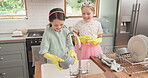 Children, water and cleaning dishes in kitchen with sister, girl or helping to wash, dry and clean house with soap. Kids, washing and cloth to wipe plates, cutlery or teaching housework to girls