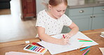 Creative, learning and girl with drawing with colour for education and childhood development. Fun, growth and art with kid is relaxing on kitchen table for schoolwork in book for motor skills.