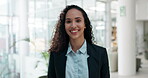 Face, smile and a corporate business woman in the office, laughing at a joke while looking proud at work. Portrait, happy and a young female employee in a suit standing in her professional workplace