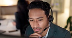 Call center, listen and man with a headset for customer service, advice or crm. Face of asian person working late at office for telecom, telemarketing or technical support at help desk with attention
