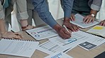 Business people, hands and writing on documents in meeting, planning or marketing strategy on office desk. Group working on paperwork in teamwork for project plan, statistics or proposal at workplace