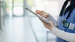 Hands, doctor and typing on a tablet at a hospital for an surgery schedule or healthcare communication. Contact, email or closeup of a nurse with technology at a clinic for medical service or nursing