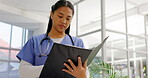 Nurse, woman and reading documents for healthcare, records or report in hospital. Paperwork, medical professional and surgeon with files for results, information and insurance folder for wellness.