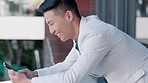 Asian man, texting and phone in office with smile for meme, online date or funny video on social media. Happy Japanese businessman, smartphone and scroll on web app for contact, communication or chat