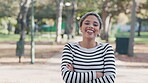 Wink, funny and portrait of woman student on a university or college campus park for outdoor break feeling happy. Smile, laughing and young female person arms crossed, confident and positive mindset