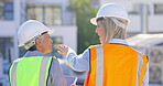 Back, teamwork and construction worker women planning a building project outdoor in a city together. Architecture, engineering or collaboration with a female designer talking to a partner for safety