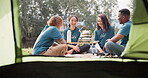 Tent, tea and a camp volunteer group talking outdoor while planning at an outreach program for the community. Forest, nature or coffee with counselor friends sitting outdoor chatting about charity