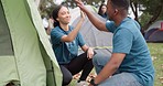 Camp, tent and people high five for teamwork and support outdoor on camping trip. A man and woman counselor together for help, team building and fun adventure in nature for summer trip success