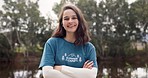 Smile, portrait of woman with confidence at summer camp and happy counsellor in nature with pride. Forest, lake and face of camping volunteer girl with arms crossed, support and leadership training.