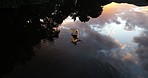 Nature, lake and kayak from above with landscape, reflection of sky and trees, relax on holiday adventure. Water, clouds and travel, person rowing on river for sport or vacation, aerial view of canoe