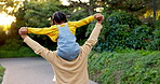 Daughter on father shoulders outdoor, back view of flying and playing game, love and bonding at home. Man, girl and family, airplane with energy and playful, freedom in backyard and trust in nature