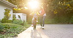 Mother, kid and learning to ride a bicycle at home for fun skill, childhood support and growth. Happy mom, sunshine and teaching cycling to young girl on bike outdoor with trust, play and development