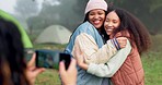 Women friends, photographer and phone at camp with hug, care and memory with smile for post on social media. People, profile picture and happy for camping, adventure and holiday in forrest together