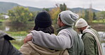 Back, walking and a couple of friends on a fishing trip by a lake in nature together while on holiday or vacation. Travel, adventure and a group of young men and women in the wilderness to explore