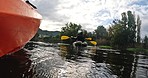 Kayaking, water sport and friends on a boat in the lake while on a vacation or weekend trip for adventure. Nature, freedom and people rowing on a river for travel while on holiday in forest or woods.