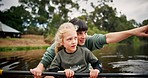 Mother, girl and pointing in kayak at lake on holiday, vacation and travel together. Happy mom, child on boat and gesture for sightseeing, bonding in river and exercise for family adventure outdoor.