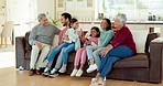 Family, TV and children on sofa with parents for bonding, quality time and relaxing in living room. Grandparents, happy and mom, dad and kids on couch streaming cartoon movies, channel and series