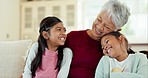 Family, grandmother and children hug on sofa for bonding, quality time and relaxing in living room. Love, happy and grandparent and girls at home having fun on couch for embrace, cuddle and laughing