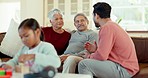 Family, conversation and father talking to grandparents for bonding, quality time and relaxing in living room. Home, children and man with senior mom and dad on sofa for chatting, speaking and love