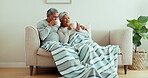 Senior couple, relax and drinking coffee on sofa with home living room blanket for love, bonding and morning routine. Smile, woman or happy elderly man with tea cup beverage on retirement house couch