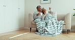 Talking senior couple, relax or drinking coffee on sofa with home living room blanket for love, bonding or morning routine. Smile, woman or happy elderly man and tea cup, pointing or retirement couch