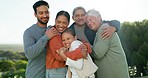 Happy, love and big family hugging in a park while on a holiday, travel or weekend trip together. Nature, smile and girl child embracing grandparents and parents with happiness in garden on vacation.