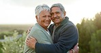 Love, happy and senior couple hugging in nature in a green garden while on romantic date. Happiness, smile and portrait of elderly man and woman in retirement embracing and bonding in an outdoor park