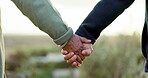 Couple, holding hands and walking at a park outdoor with love, commitment and care in summer. Closeup of a man and woman together on an adventure, travel and romantic stroll for freedom or to relax