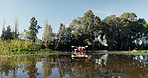 People, kayak and rowing on a lake in nature for sports challenge, adventure or travel with a smile. Friends together on a boat and river for fitness, workout and holiday or journey for freedom