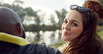 Happy, face and woman with friends on lake, camping in nature or group laughing and bonding on outdoor picnic at the park. Portrait, girl or smile in conversation, social gathering or relax in woods