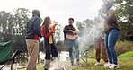 Friends, bonfire and guitar with singing, dancing and happy together in nature, woods or park for holiday. Men, women and excited for freedom, chat and camping by fire for music, forrest and vacation