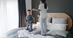 Happy, bed and children jumping in the morning for energy, crazy and funny together in a home. Smile, young and excited kids, siblings or friends in the bedroom with joy, comic and friendship