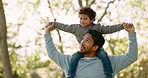 Nature, walk and father with his child on his shoulder in an outdoor park for fresh air. Talking, bonding and young man carrying his boy kid by the trees in a green garden together on a weekend trip.