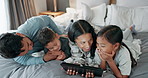 Children, parents and tablet in bedroom for games, online story and streaming multimedia. Mom, dad or happy family with kids relax in morning on digital technology, watching cartoon or movies at home