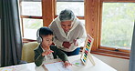 Grandmother, boy child and headphones with learning, book and study for development, care and bonding at desk. Senior woman, grandchild and together for education, applause and music in family house