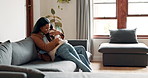 Family, mother and girl hugging on a sofa in the living room of their home together for love, trust or bonding. Smile, embrace and tender with a woman parent holding her adorable little daughter