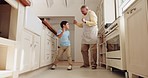 Dancing, kitchen and senior man with his grandchild having fun, bonding and listening to music. Happy, smile and grandfather moving with a boy kid to a playlist, radio or song while cooking in a home