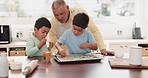 Kitchen, baking and boy children with their grandfather for sweet treats, dessert or snack. Bonding, ingredients and kids with sprinkles for cookies or biscuits with senior man for child development.