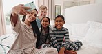 Selfie, funny and happy family in home bedroom, bonding and laughing together. Profile picture, smile and parents with kids, interracial mother and father taking photo for social media after adoption