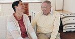 Funny, sofa and elderly couple laughing together at a joke while bonding and enjoy retirement in a home with love. Comedy, humor and senior people in a living room or man and woman in happiness