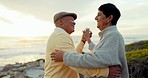 Sunset, dance and senior couple at beach, happy and bond on holiday. Romantic, elderly man and woman at sea, smile and enjoy quality time together in retirement with love on vacation outdoor at ocean