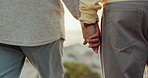 Couple, love and holding hands and walking on beach for care, commitment or adventure outdoor. Closeup of man and woman together for freedom, peace or support on holiday, travel or sunset vacation
